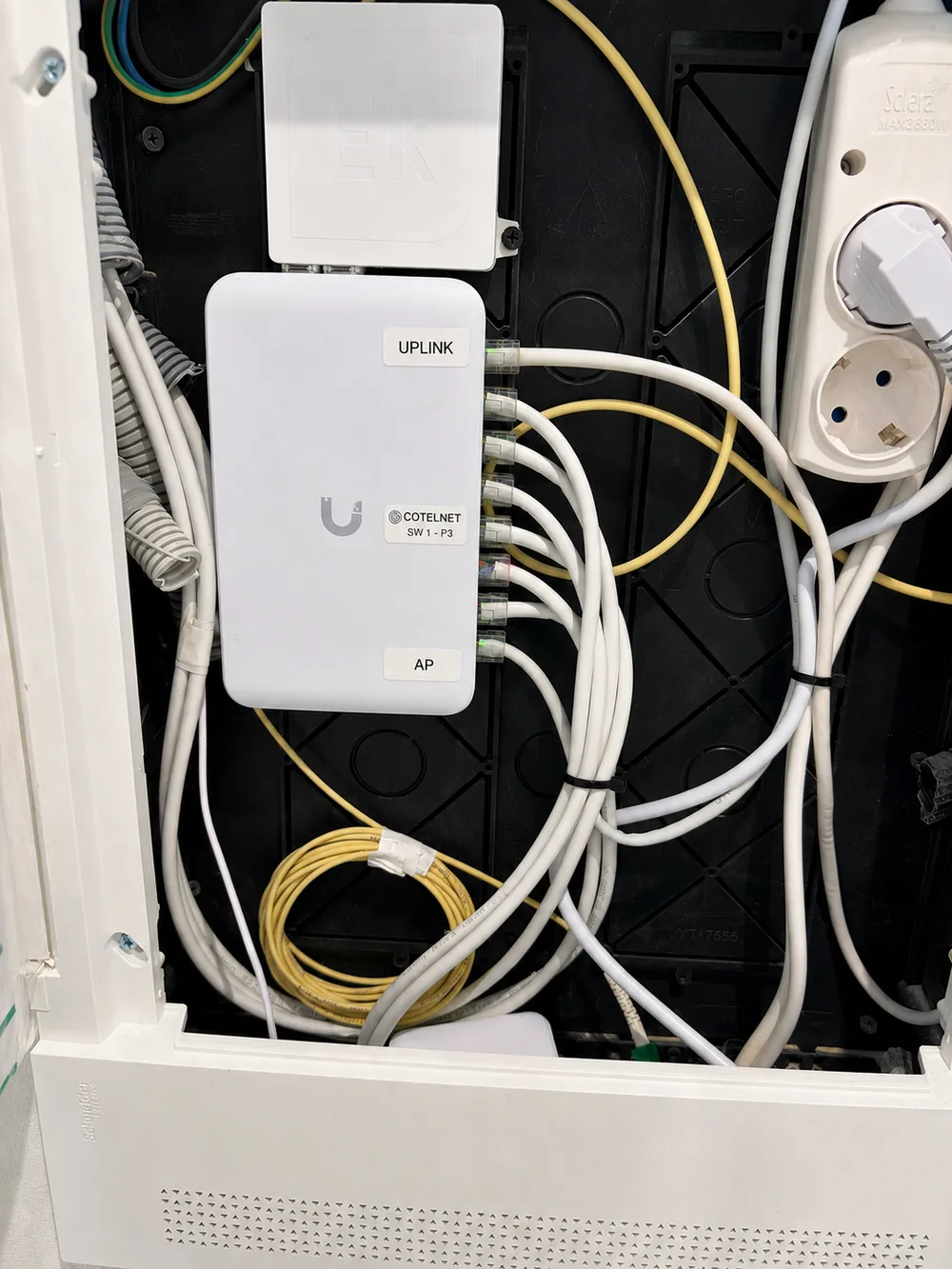 Switch PoE UniFi USW-Lite-8 etiquetado en el armario de una vivienda